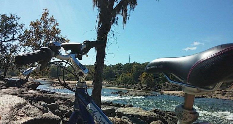 Bike resting on railing at the edge of the Chattahoochee River. Photo by Tracie Sanchez.