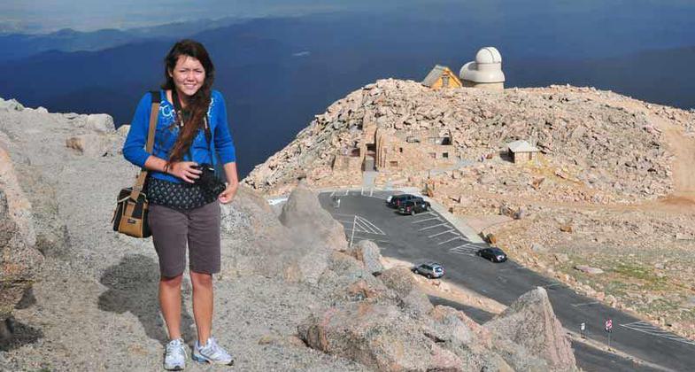 Young photographer on the Mt. Evans NRT summit trail, with the parking area below; Photo by Kim Schmidt.