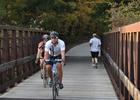 Bicyclists and joggers crossing a bridge on the Neal Smith Trail. Photo by Dayne Magneson.