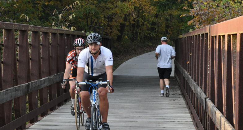 Bicyclists and joggers crossing a bridge on the Neal Smith Trail. Photo by Dayne Magneson.