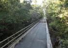 Cyclists take the bridge along this very straight trail.