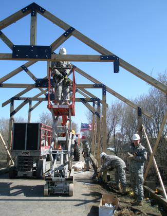 Volunteer Army Reservists attach brackets on bridge. Photo by Chuck Wocken.