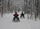 Snowmobilers enjoying fresh snow on this 200 mile trail!. Photo by cadillacmichigan.com.