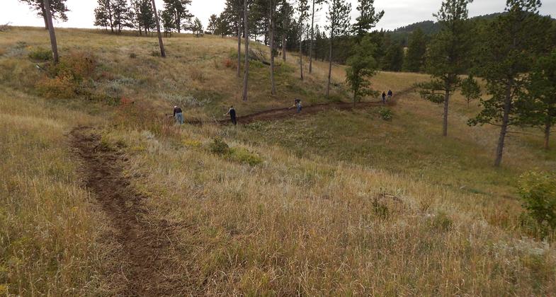 Finishing touches on the trail. Photo by Ryan Larson.