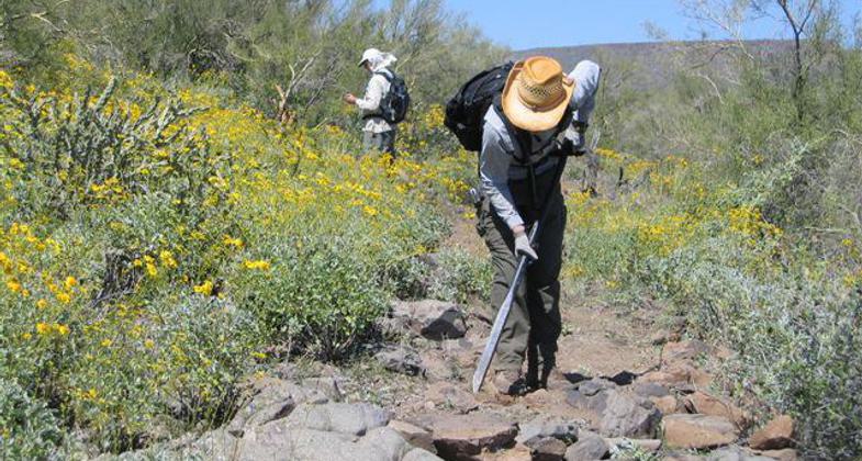 Troy Dymock of U.S. Forest Service Enterprise Team applies a rock bar to tough rocks. Photo by Rich Hanson.