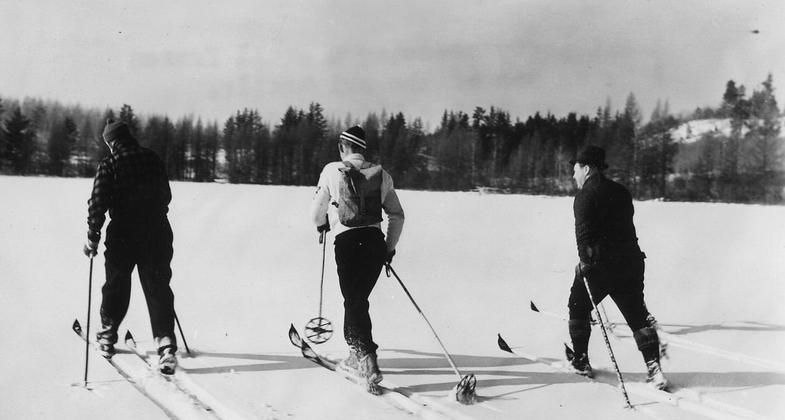 Vintage 1940 ski party crossing  a small frozen lake on one of the ski trails at Shingobee Winter Playground. Photo by Dept of Agriculture/wiki.