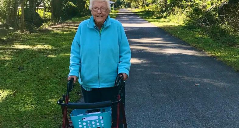 Dog walker on trail. Photo by FL Office of Greenways.