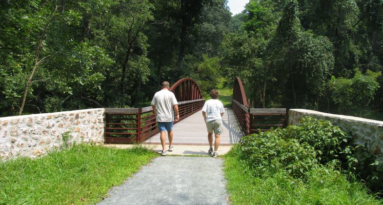 Walking over a pedestrian bridge on the Pomeroy and Newark Rail Trail. Photo by Avery Dunn.