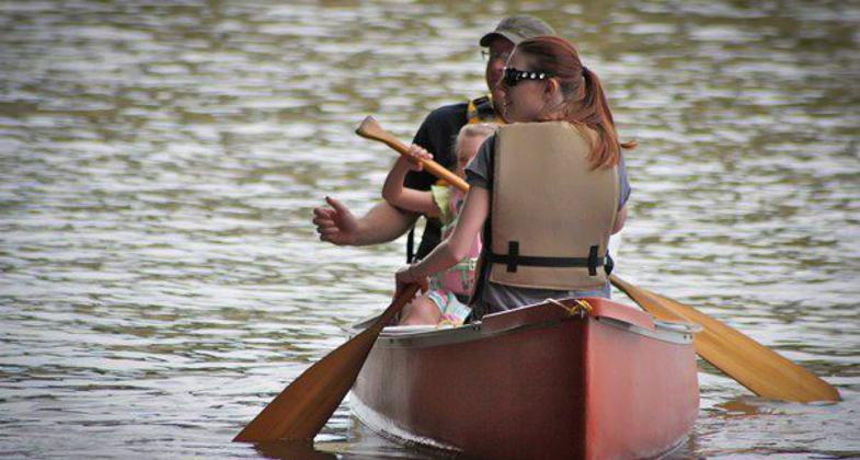 A family canoes on the Arkansas River.