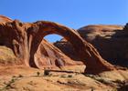 Hikers beneath Corona Arch. Photo by Valerie A. Russo. Photo by Bill Stevens