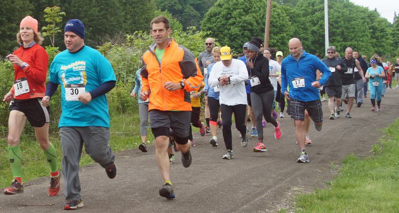 Woman runner on the Jim Mayer Trail Family Fun Run, along the Stonycreek River in Johnstown PA. Photo credit: Erica Claycomb.