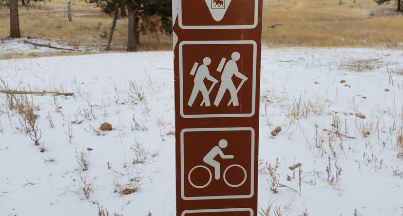 This photo is of the signage posted on the trailhead kiosk that explains trail etiquette for the winter months when snow is present on the trails.