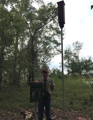 Eagle Scout Eric Medrano with his interpretive project, a rocketbox bat house and signage on the trail hear the Knobby Knees Trailhead.