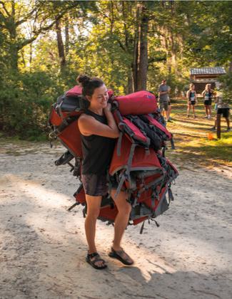 girl carrying PFDs