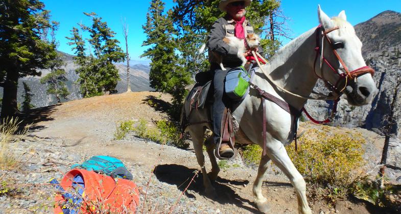 Big Jim, of the Backcountry Horseman, and his dog, Millie, both on their way to bring tools and supplies up to the crew. Photo by Liam Downs-Tepper.