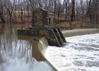 Historic Speedwell Lake Dam on Patriots Path, in Morristown, NJ with the remains of an 18th century iron works opposite the dam;.
