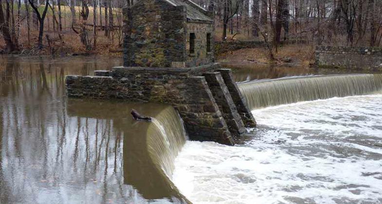 Historic Speedwell Lake Dam on Patriots Path, in Morristown, NJ with the remains of an 18th century iron works opposite the dam;.