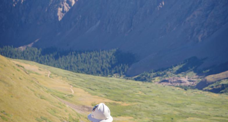 A volunteer with Volunteers for Outdoor Colorado and Colorado Fourteeners Initiative move logs at around 13,000 feet on the Grays Peak Trail. These were installed as check steps on the trail to prevent erosion.